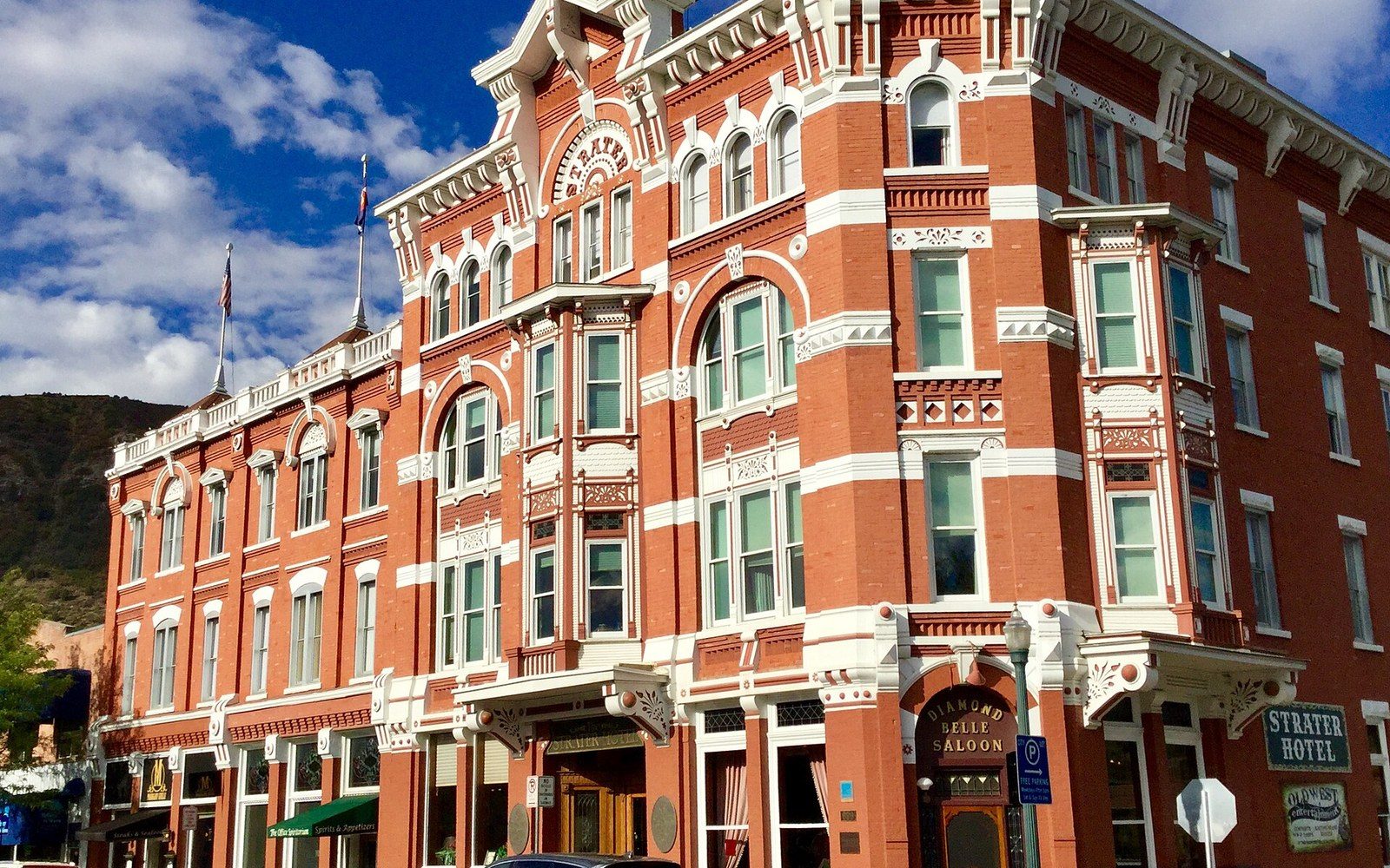 The Strater on Main Avenue — four floors of pressed brick, opened 1887, on the National Register.